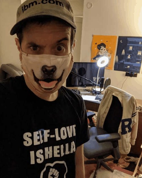 Brendan in his home office wearing a dog mask and an ibm.com hat, with podcast mic and lighting in the background.